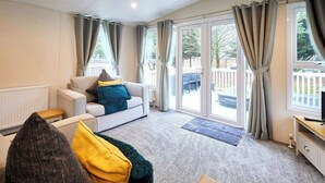 Een moderne woonkamer met een bank, een klein tafeltje en een tv-meubel.