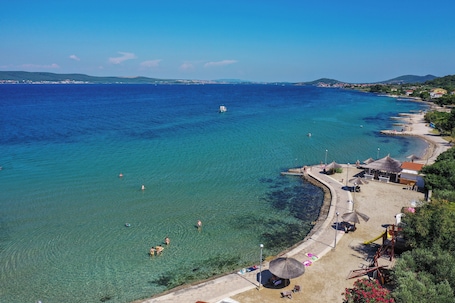 On the beach, white sand, 2 beach bars, kayaking. Villa