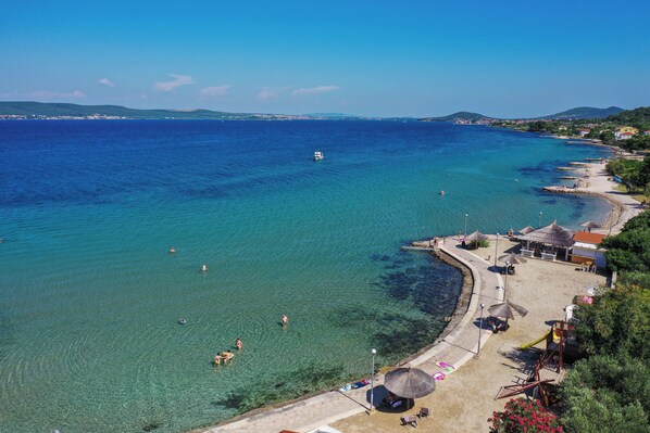 On the beach, white sand, 2 beach bars