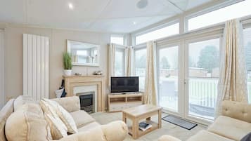 A living room with a fireplace, television, and comfortable seating.