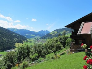 A wooden chalet with a balcony overlooking a valley with mountains in the background. - Rosskopf by Interhome (Wildschönau)