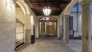 A hallway with a wooden ceiling, a wrought iron gate, and a stained glass door. - Residence in Como with 0 bedrooms sleeps 2 (Como)