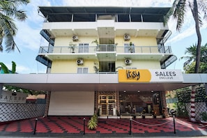 A multi-story hotel with balconies, air conditioning units, and a sign for 'itsy SALES ENCLAVE'. - Itsy Hotels Salees Enclave - Near Padmanabhaswamy Temple (Thiruvananthapuram)