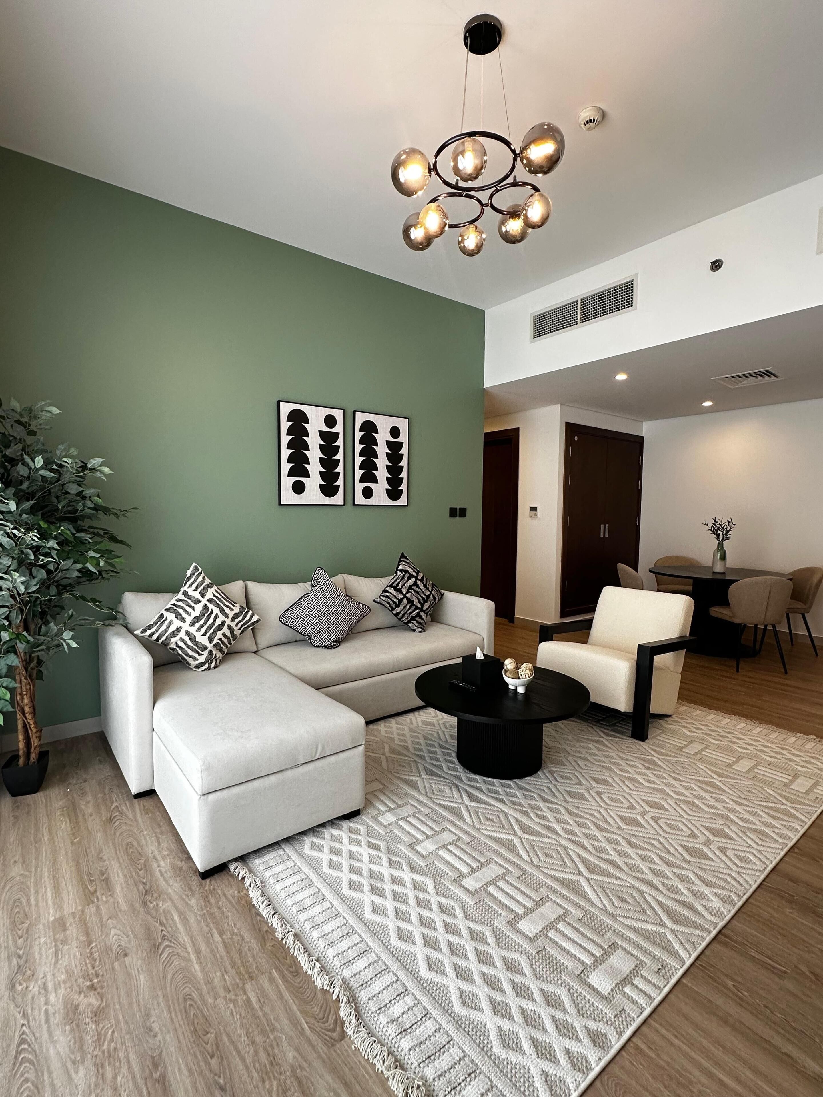 A modern living room with a sofa, coffee table, and decorative wall art.