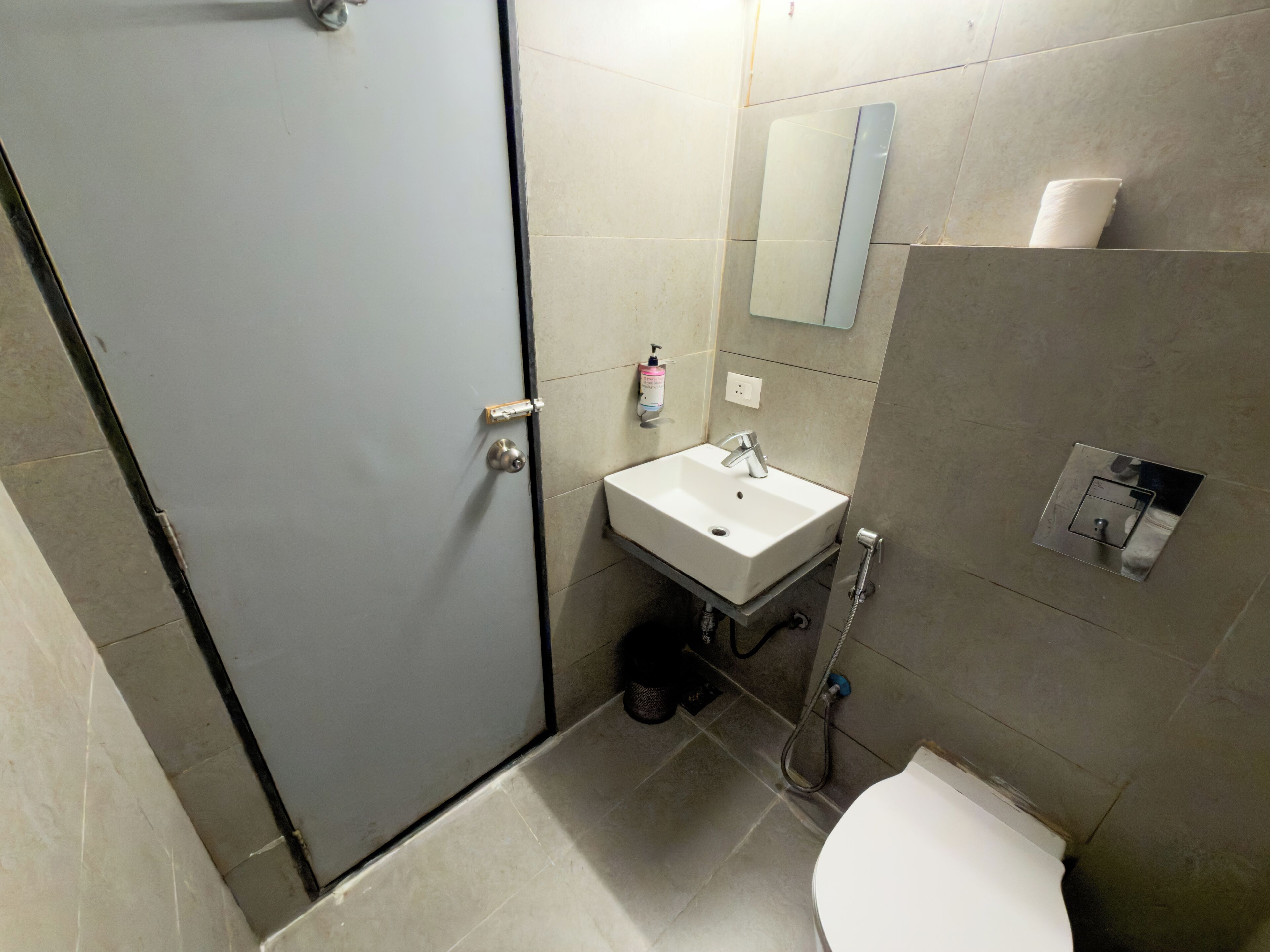 A bathroom with a toilet, sink, and shower.