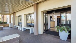 A modern outdoor seating area with benches and a potted plant. - SUN1 Parow Cape Town (Cape Town)