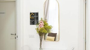 A white door with a sign indicating "ROOM 1" and a mirror with a gold frame. - Mega Random By Dimorra (Naples)