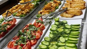 A buffet with various food items including salads, fruits, and appetizers. - Shedevr plaza (Namangan)