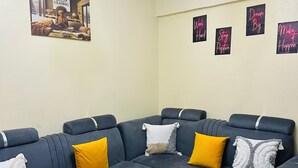 A modern living room with a sectional sofa, a round coffee table, and motivational wall art. - ✨ Elegant 1-Bedroom  – Comfort, Class & Peace ✨

📍 Located along TRM Drive (Nairobi)