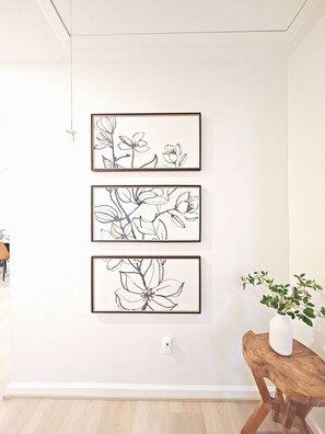 A wall with three framed botanical illustrations. - Augustine · 10 min to NRG and the Medical Center · 2 baths (Houston)