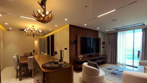 A modern living room with a TV, seating, and a bar area. - 
Luxury Apartment at Oberoi Maxima Near Airport Andheri Mumbai (Mumbai)