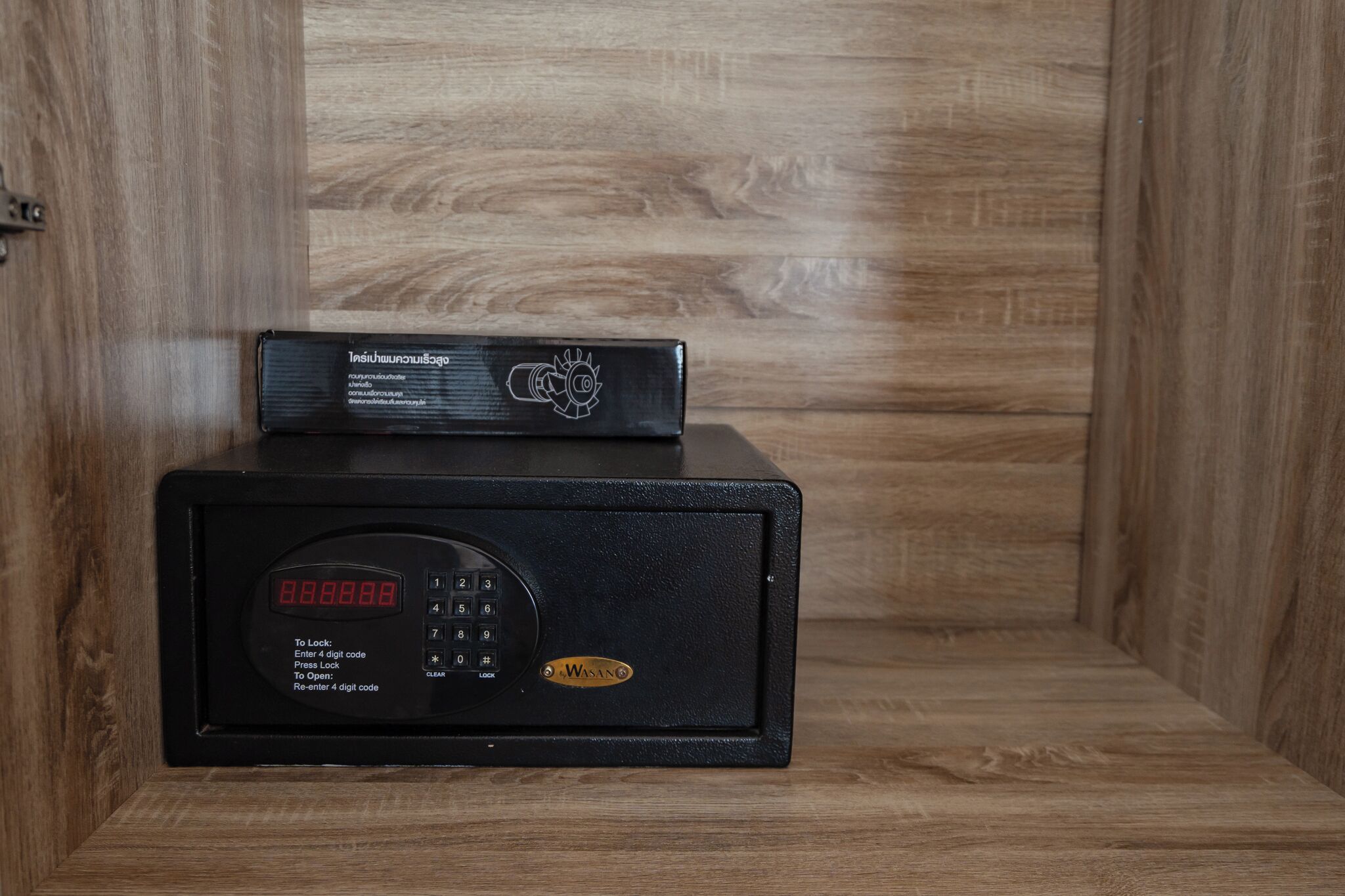 A black safe with a digital lock screen and a keypad.