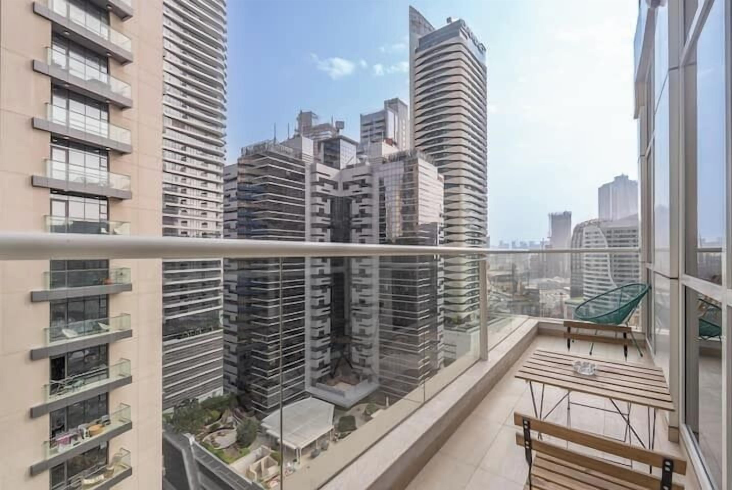 A high-rise building with a modern design, featuring balconies and large windows.