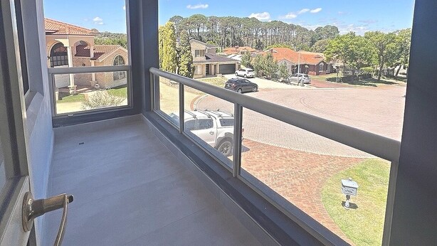 A room with a large window overlooking a parking area and a residential neighborhood. - Room-executive Style Stay, Fast Wi-fi, p (Perth)