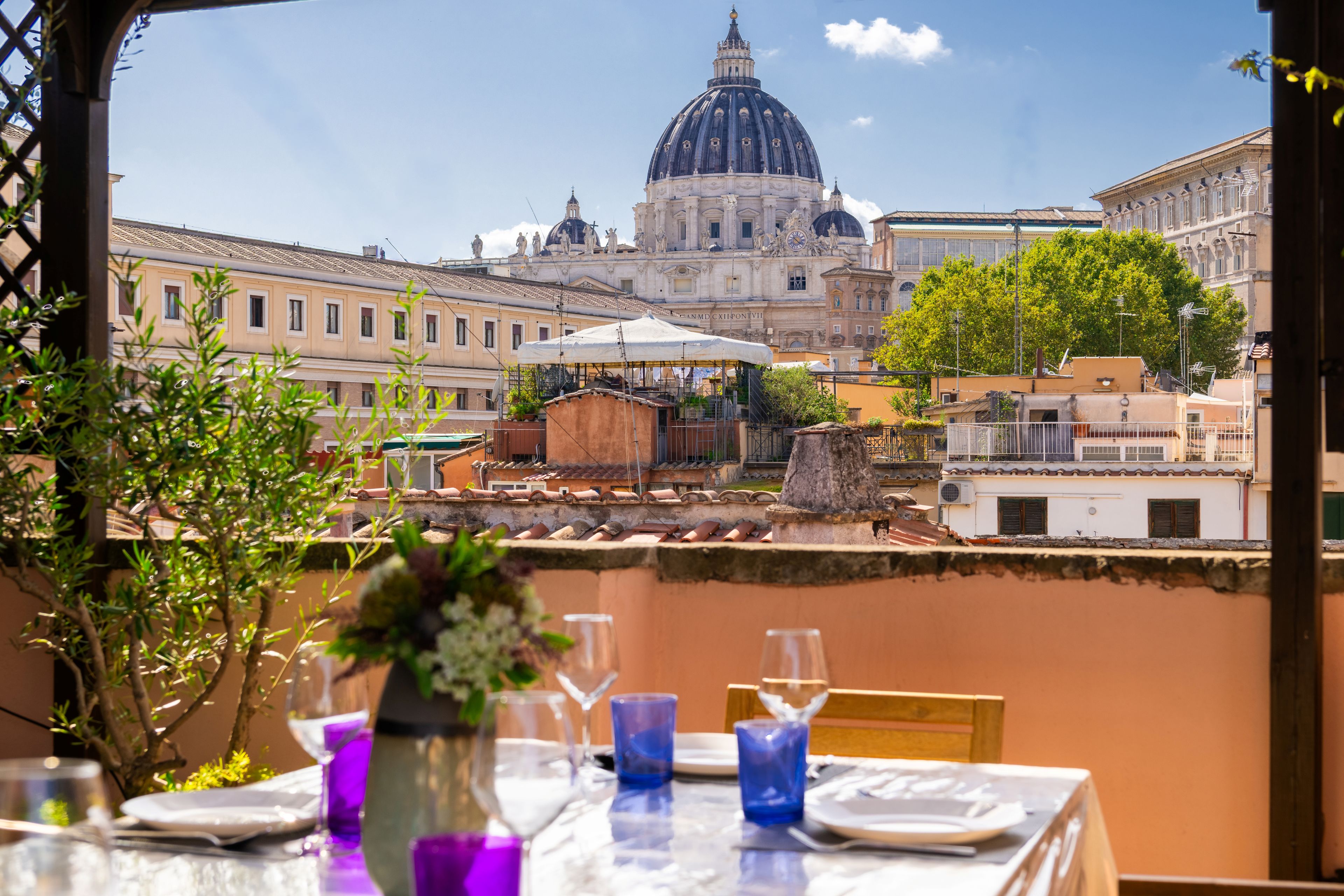 A table set for dining with a view of a historic building with a dome.