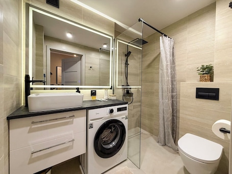 Shower, hair dryer, toilet paper. Fly Apartment Modlin by JumpInHere