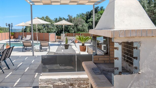An outdoor patio with a barbecue grill, seating area, and umbrellas. - Altura Villa,Private Pool , one storey , for Up to 7 geusts (Saitoures)
