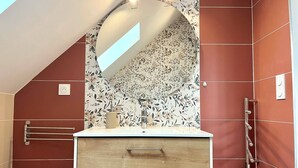 A bathroom with a wooden vanity, a mirror, and a shower area. - La Maison Agoméa (Saint-Georges-sur-Cher)