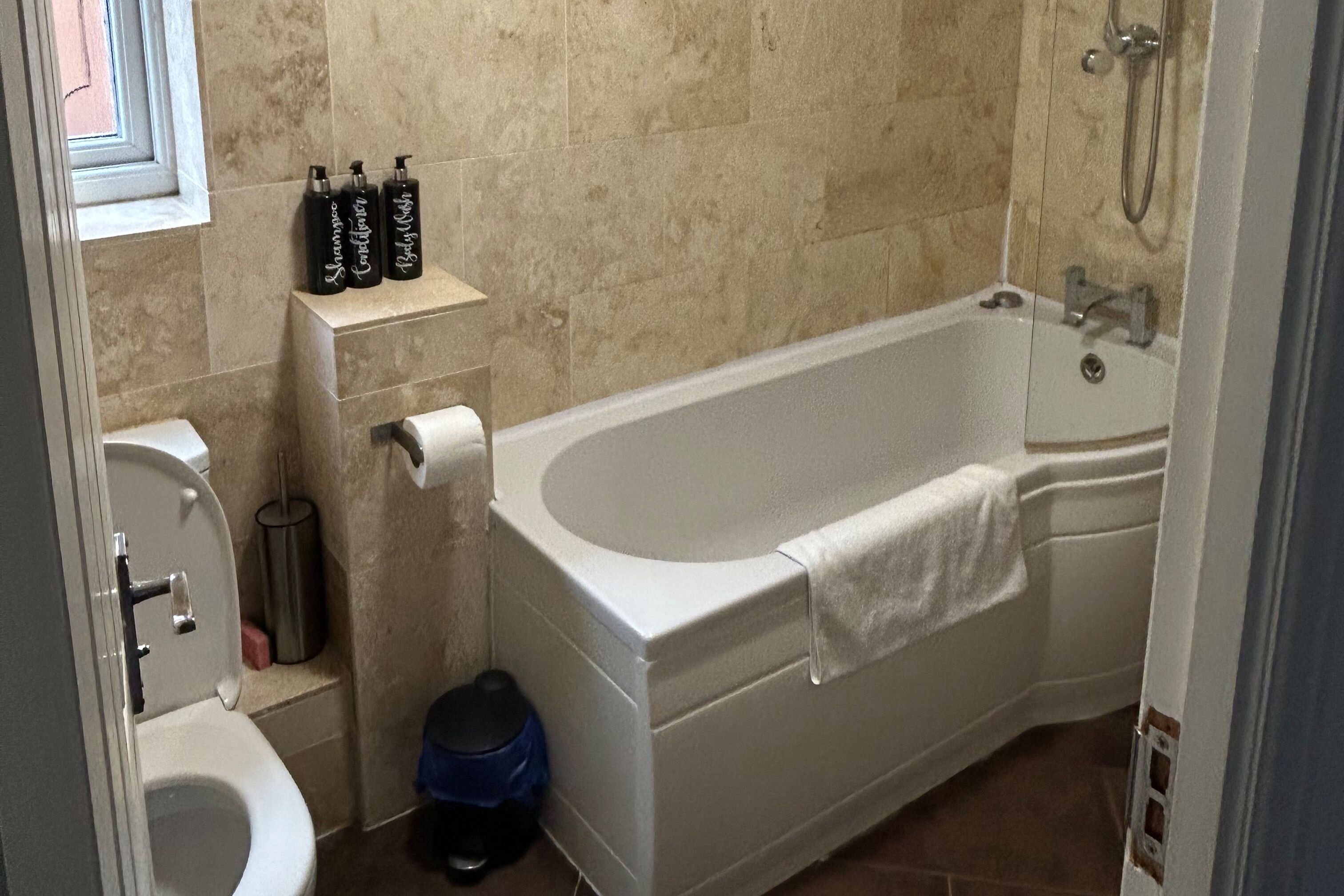 Combined shower/bathtub, deep-soaking bathtub, towels