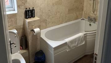Combined shower/bathtub, deep-soaking bathtub, towels