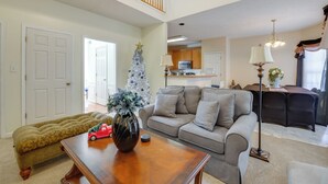 A living room with a sofa, coffee table, and a Christmas tree. - Great for Families! Suburban Home in Ruther Glen (Ruther Glen)