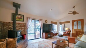 A living room with a fireplace, television, and comfortable seating. - On 10 Acres! Serene Nevada City Retreat w/ Hot Tub (Nevada City)