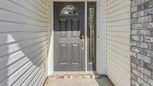 A front door with a dark-colored panel, a glass panel above it, and a small step leading up to the door. - Pool Access & Pond Views: Longs Home Near Golf! (Longs)