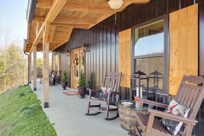 A wooden porch with rocking chairs and potted plants. - Nature Meets Nashville! Mtn-view Home in Hickman (Hickman)