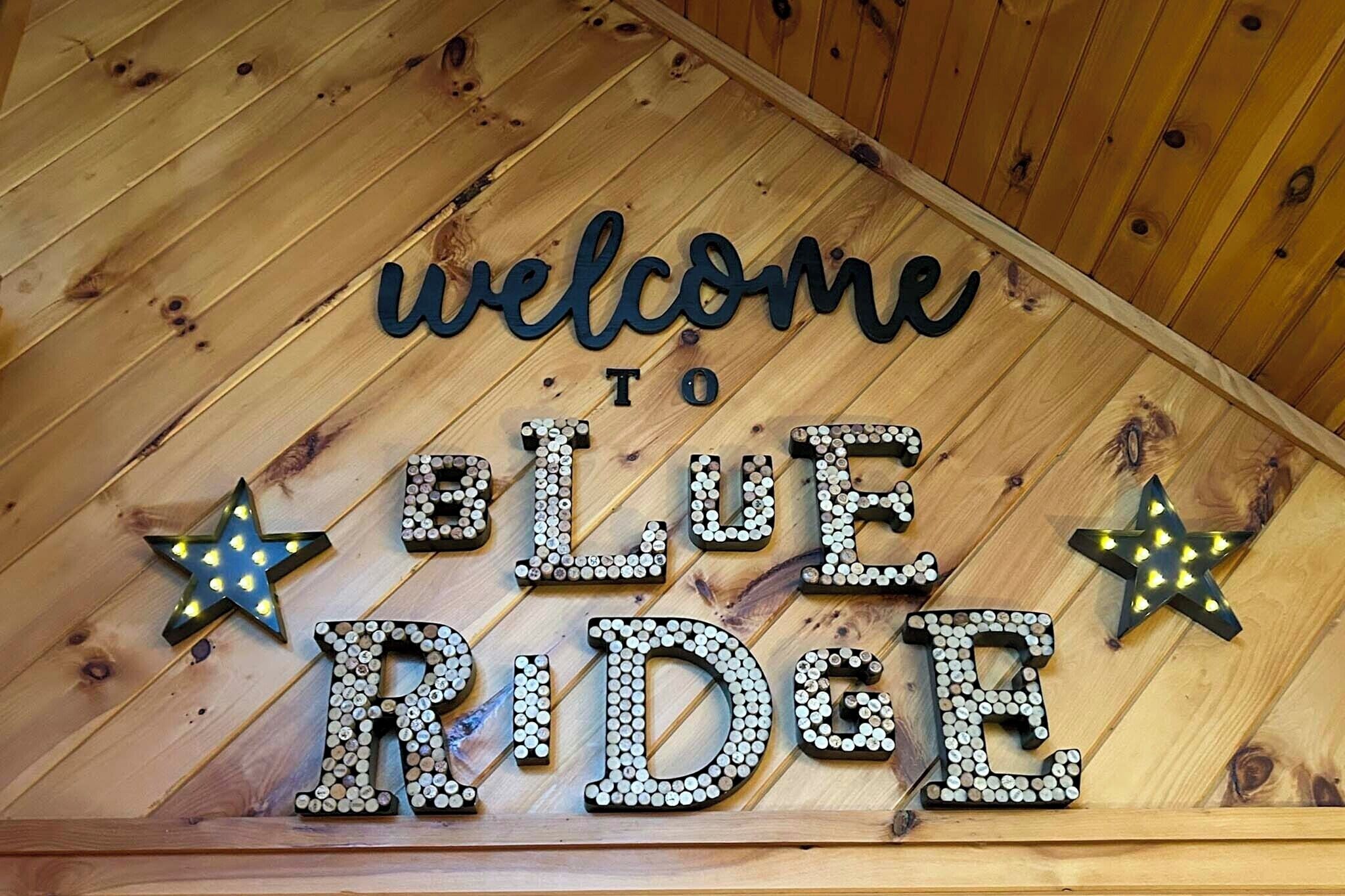 A wooden wall with a welcome sign to Blue Ridge.