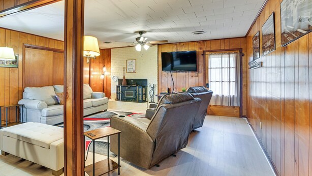 A cozy living room with a sofa, a coffee table, and a television. - 2 Mi to MSU Campus! Family Abode w/ Spacious Yard (Starkville)