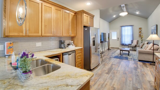 A modern kitchen with wooden cabinets, a stainless steel refrigerator, and a marble countertop. - Dog-friendly Home: Near Hot Springs Natl Park! (Hot Springs)