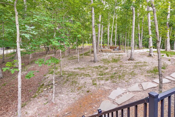 A forested area with a stone pathway and a wooden fence.