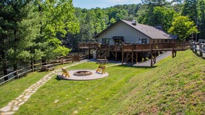 A lodge with a deck, a fire pit, and a pond. - Smore than enough! Powder Horn Mountain - 3K,2 twin bunks, Pets OK,Pool table (Deep Gap)