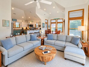 A spacious living area with two sofas, a coffee table, and a dining table with chairs. - Saltwater Gospel - Oceanside 5 BR home w/Private Pool, Dogs Allowed (Duck)