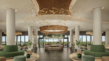 A spacious lobby with a central reception desk, seating areas, and large windows offering a view of the cityscape.