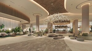 A spacious lobby with a central bar, seating areas, and large windows. - Rotana Ras Al Khaimah - The Mangroves (Ras Al Khaimah)