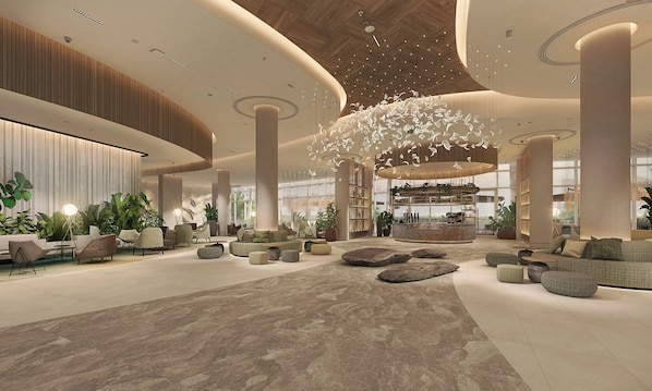 A spacious lobby with a central bar, seating areas, and large windows. - Rotana Ras Al Khaimah - The Mangroves (Ras Al Khaimah)