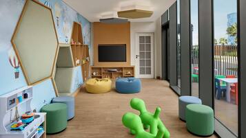 A children's playroom with a large window, play area, and a TV.