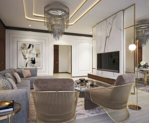 A modern living room with a sofa, armchairs, a coffee table, a TV, and a chandelier.