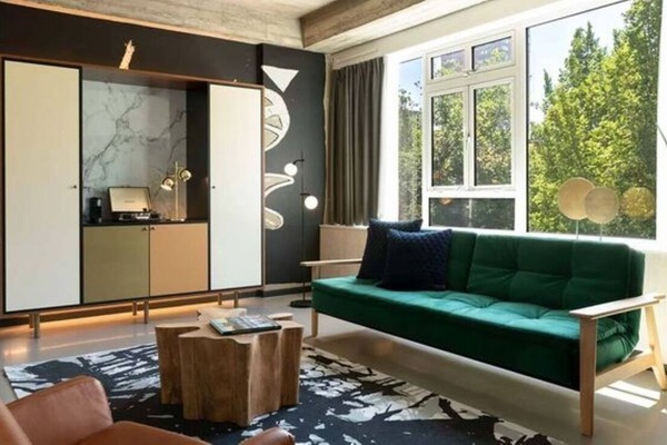 Stretch out on the plush sofa in a bright, stylish lounge.
