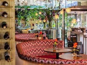 A restaurant with zigzag patterned booths, round tables, and hanging spherical light fixtures. - Modern Comfort in Rotterdam Near Shops, Nightlife & Cultural Sights (Rotterdam)