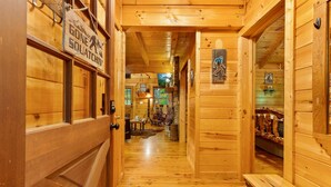 A wooden interior hallway with a sign reading "Gone Squatchin'". - Finding Bigfoot 2 Bedroom Cabin (Sevierville)