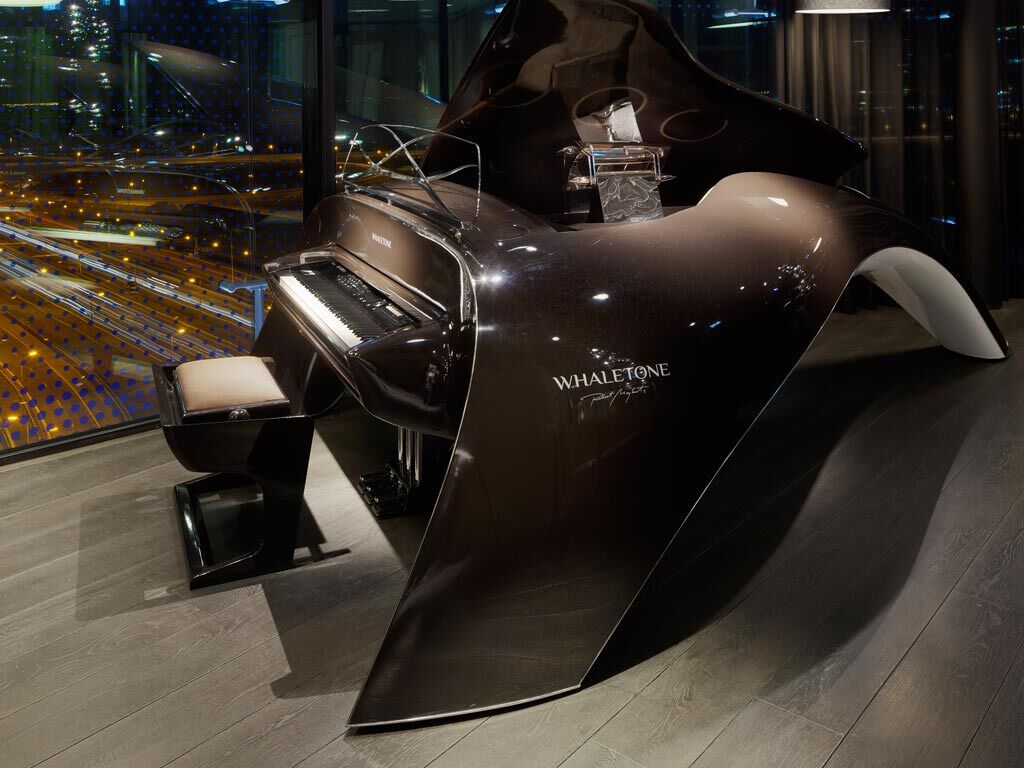 A piano with the label "WHALETONE" in a modern, curved design.