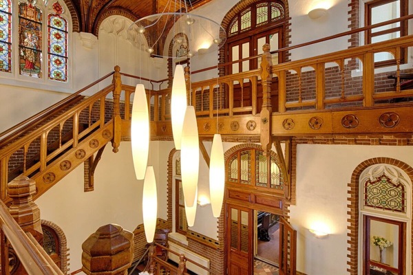 Wander beneath stained-glass ceilings and warm, elegant detailing.