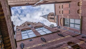 A high-rise building with a distinctive architectural style, featuring multiple windows and a brick facade.