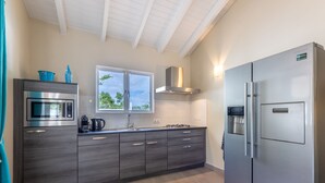 A modern kitchen with a stainless steel refrigerator, double sink, and built-in microwave. - Villa Drumi Dushi met privé zwembad by Interhome (Jan Thiel)