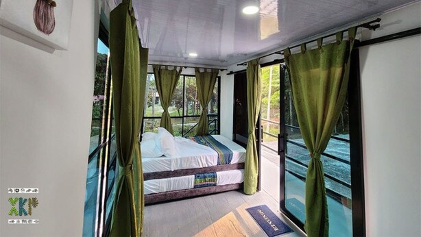 A bedroom with a bed, curtains, and a view of the outdoors. - Encanto Llanero by Interhome (Villavicencio Meta)