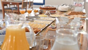 A buffet table with various food items and beverages. - Quinta das Águas by Summit Hotels (Itapira)