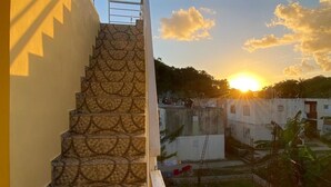A staircase with a patterned tile design leading to a balcony.