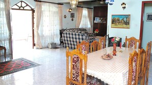 A dining area with a checkered tablecloth, wooden chairs, and a chandelier. - Dominic's Home by Interhome (Weligama)